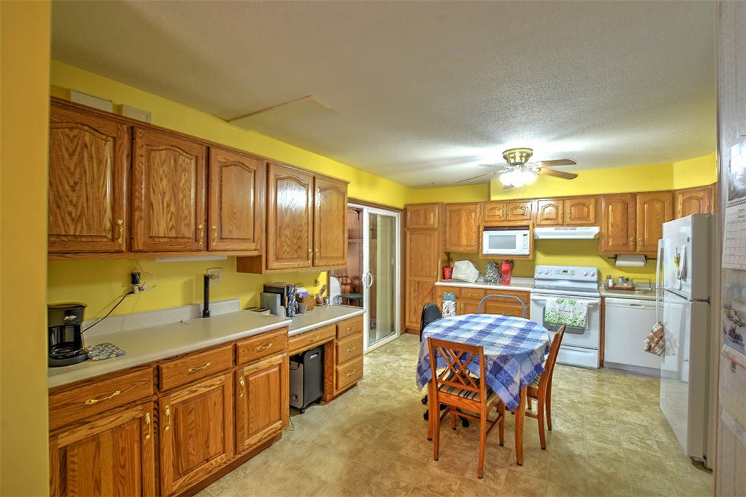 3055 Long Creek Road Decatur, IL 62521 - Photo 11 of 29 a kitchen with a sink refrigerator and cabinets