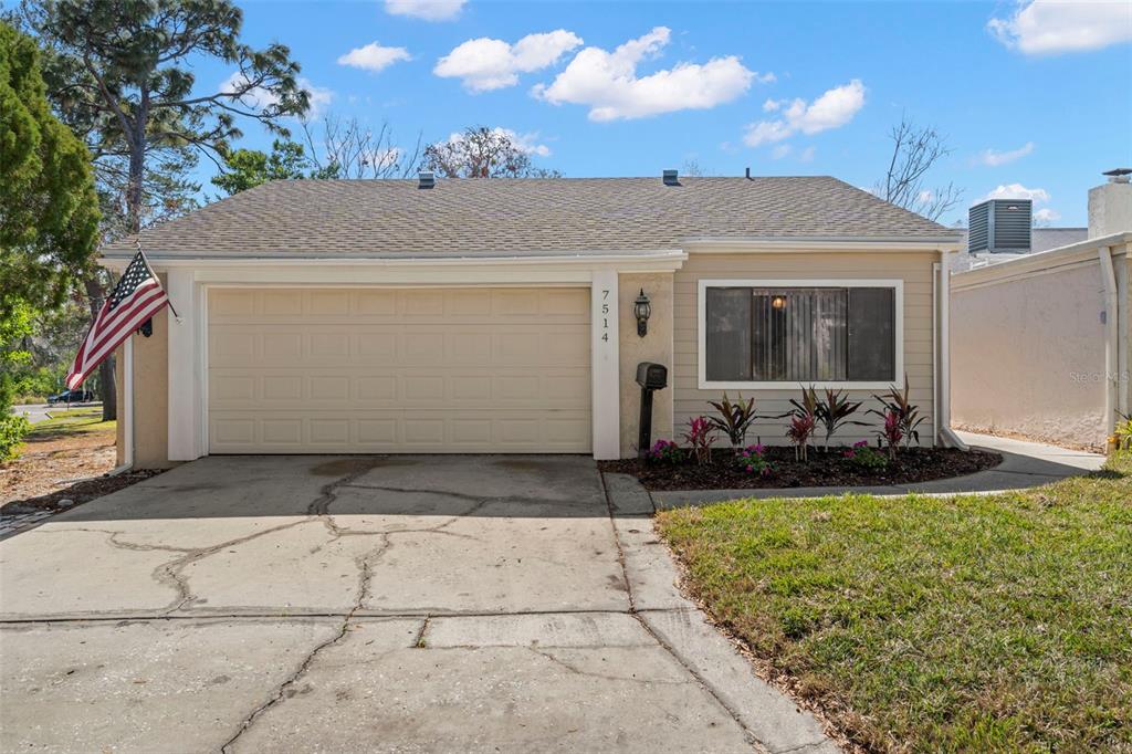 a view of a house with backyard and sitting area