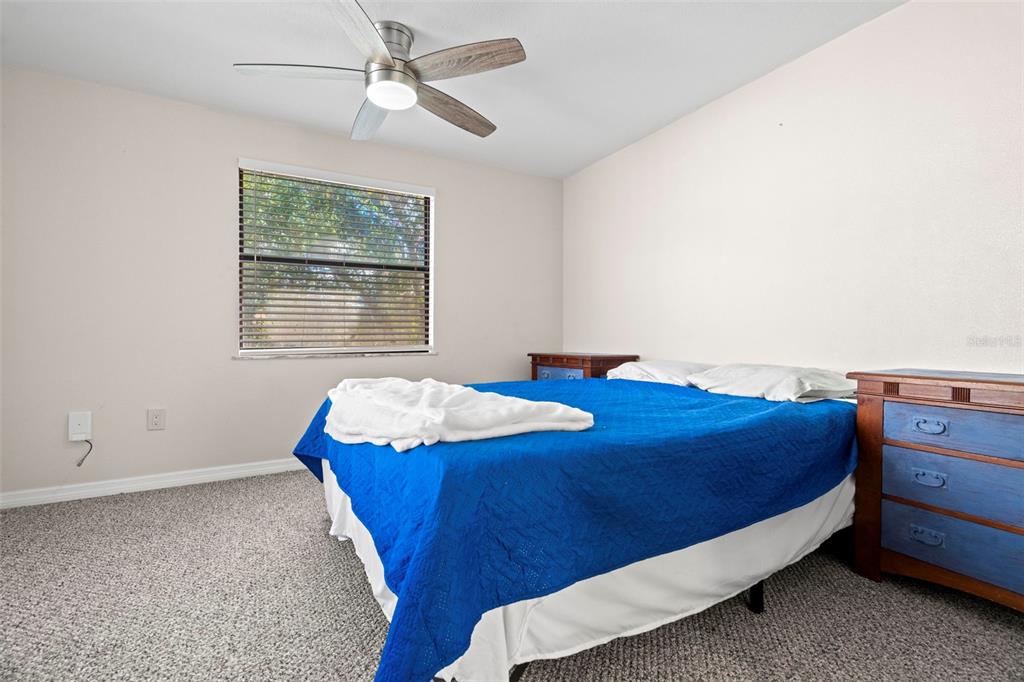 7514 Rocky Point Drive Hudson, FL 34667 - Photo 20 of 38 a bed sitting in a bedroom next to a window