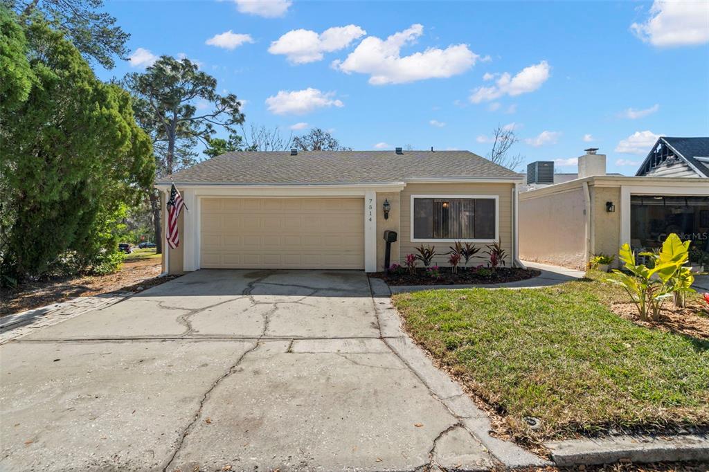 7514 Rocky Point Drive Hudson, FL 34667 - Photo 27 of 38 a front view of a house with garden