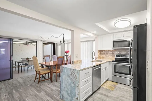 a kitchen with a refrigerator stove and microwave