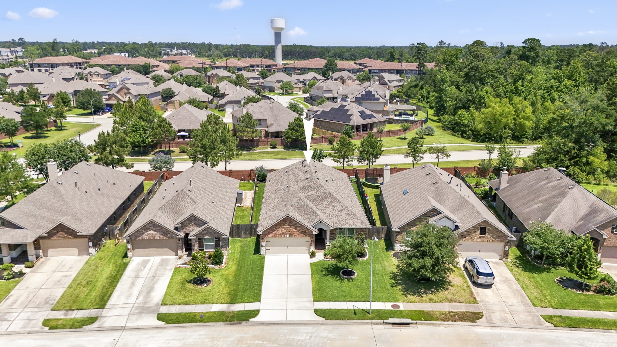 5522 Glenfield Spring Lane Spring, TX 77389 - Photo 39 of 46 This photo showcases a suburban neighborhood with well-maintained single-family homes, each featuring a driveway and garage.