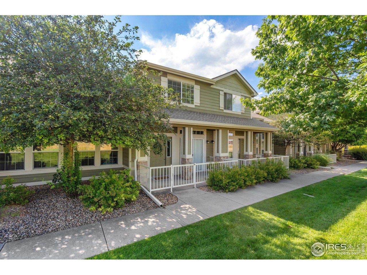1900 68th Avenue, Unit 4 Greeley, CO 80634 - Photo 1 of 40 a front view of a house with garden