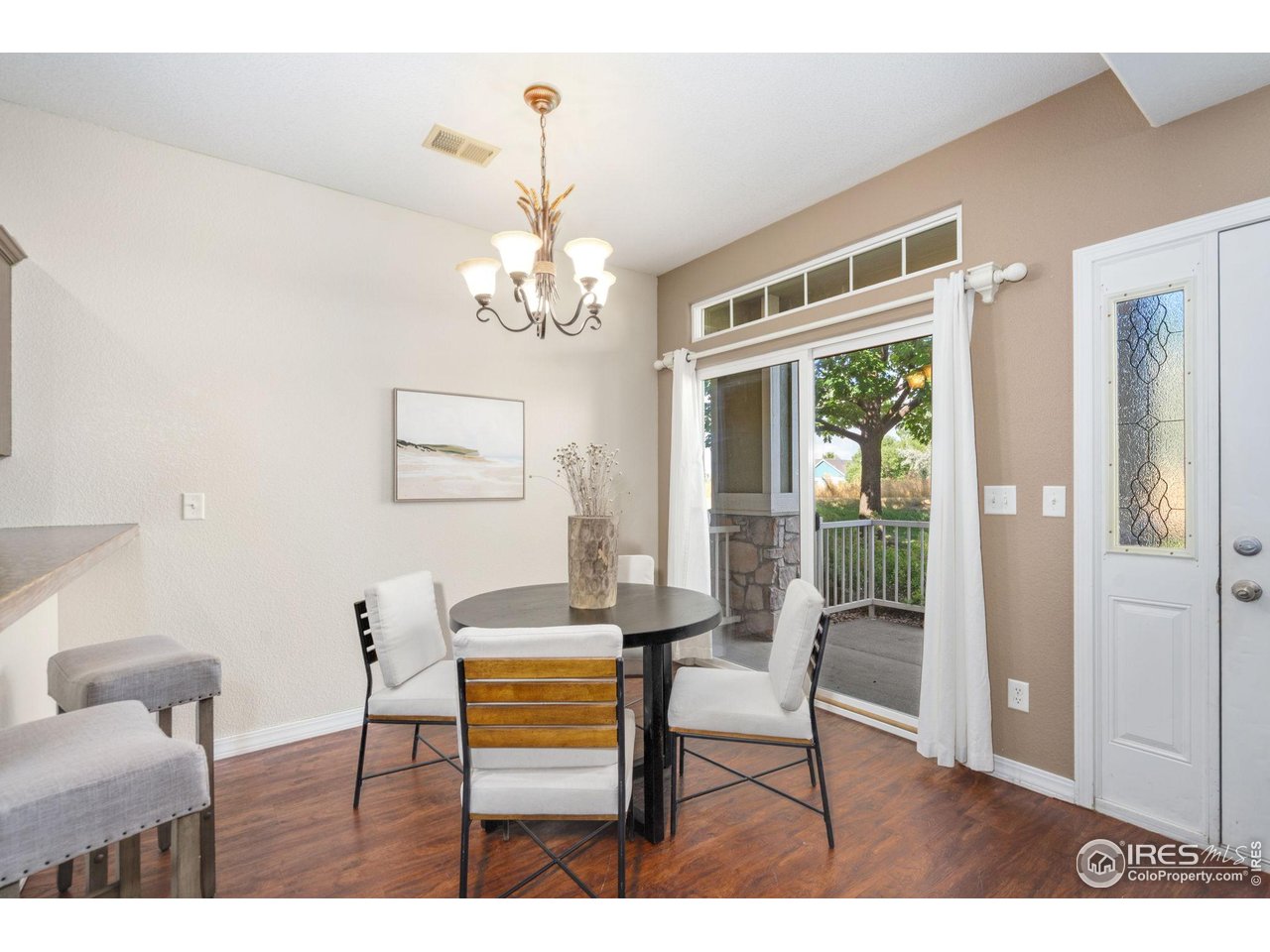 1900 68th Avenue, Unit 4 Greeley, CO 80634 - Photo 11 of 40 a view of a dining room with furniture wooden floor and a chandelier