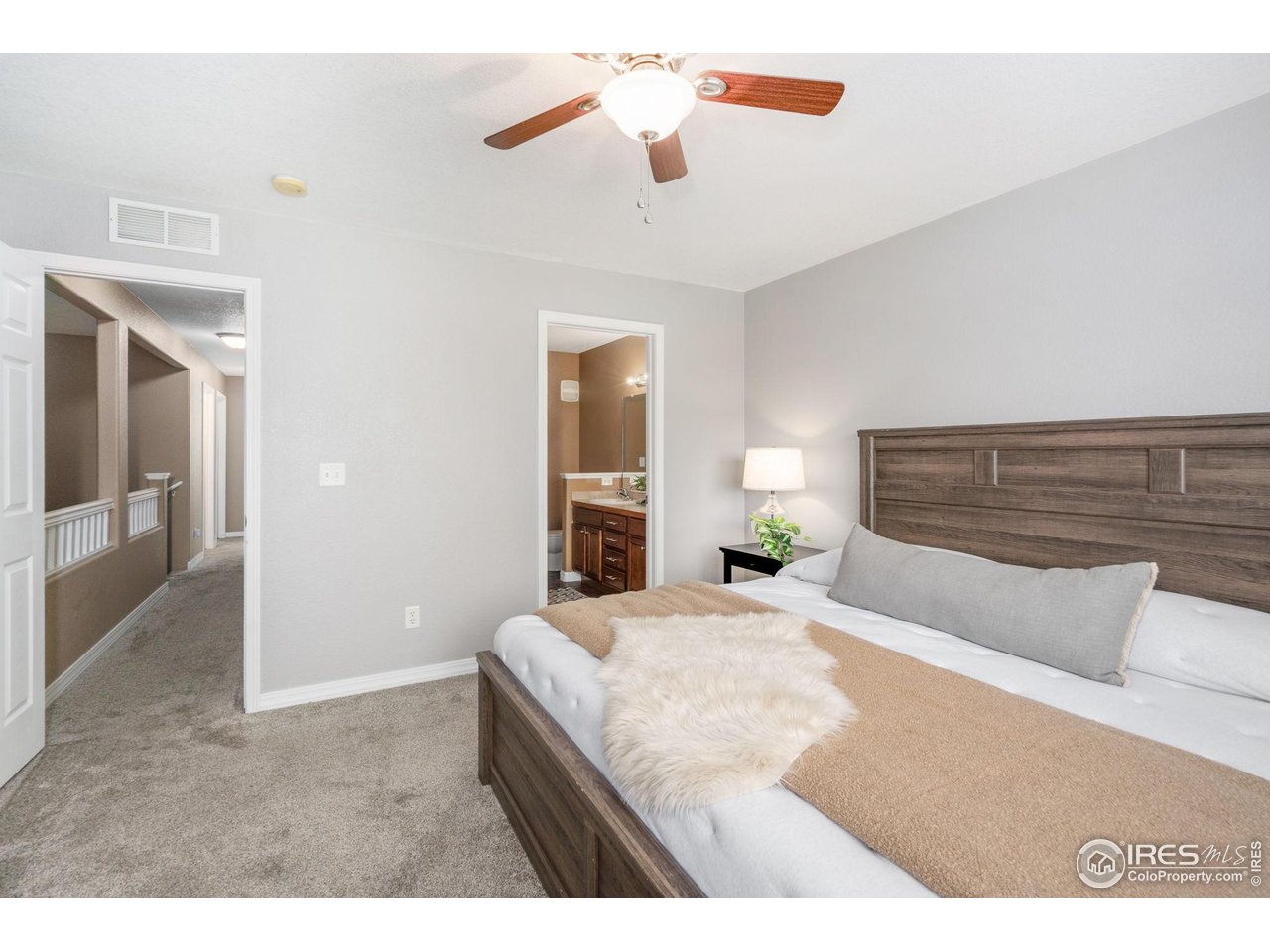1900 68th Avenue, Unit 4 Greeley, CO 80634 - Photo 15 of 40 a bedroom with a bed and a chandelier