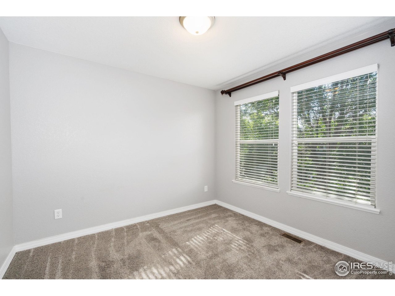 1900 68th Avenue, Unit 4 Greeley, CO 80634 - Photo 20 of 40 a view of an empty room with a window