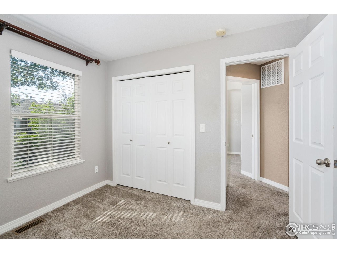 1900 68th Avenue, Unit 4 Greeley, CO 80634 - Photo 21 of 40 a view of an empty room with a window