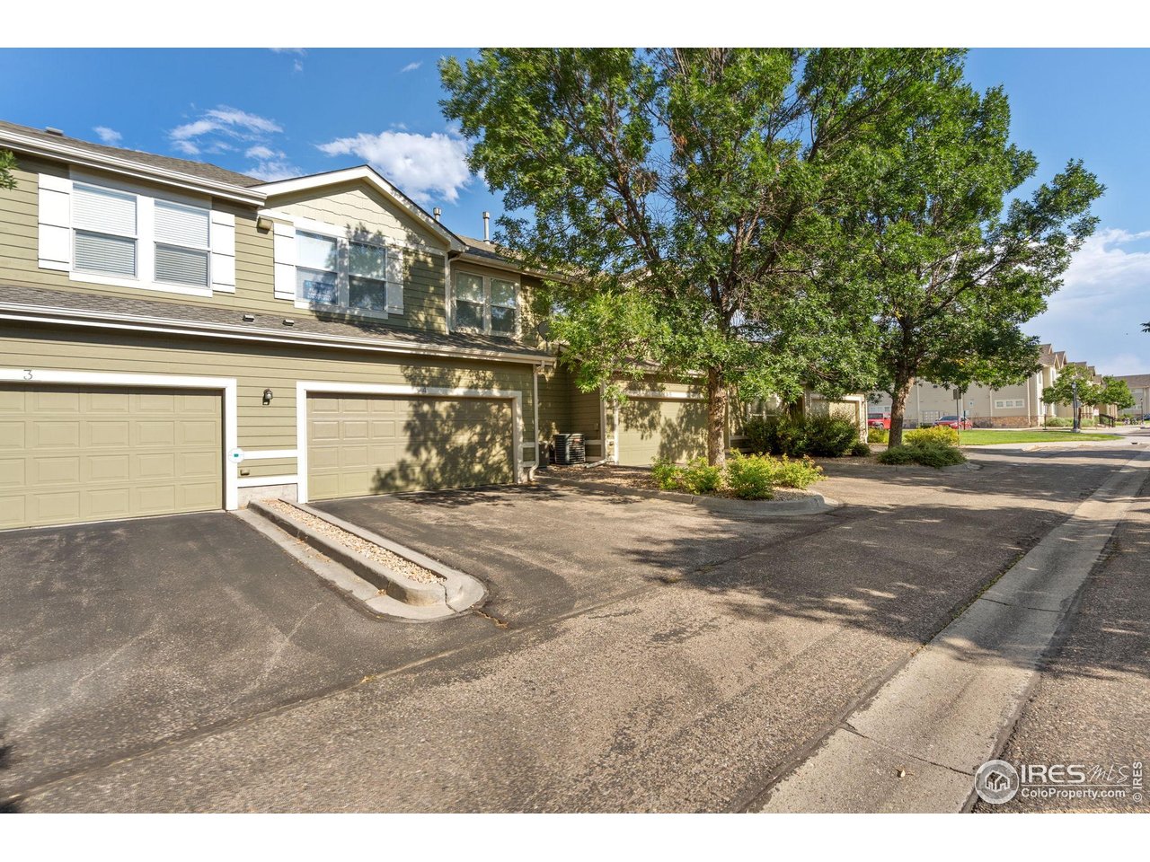 1900 68th Avenue, Unit 4 Greeley, CO 80634 - Photo 34 of 40 a view of a house with a yard and a garage