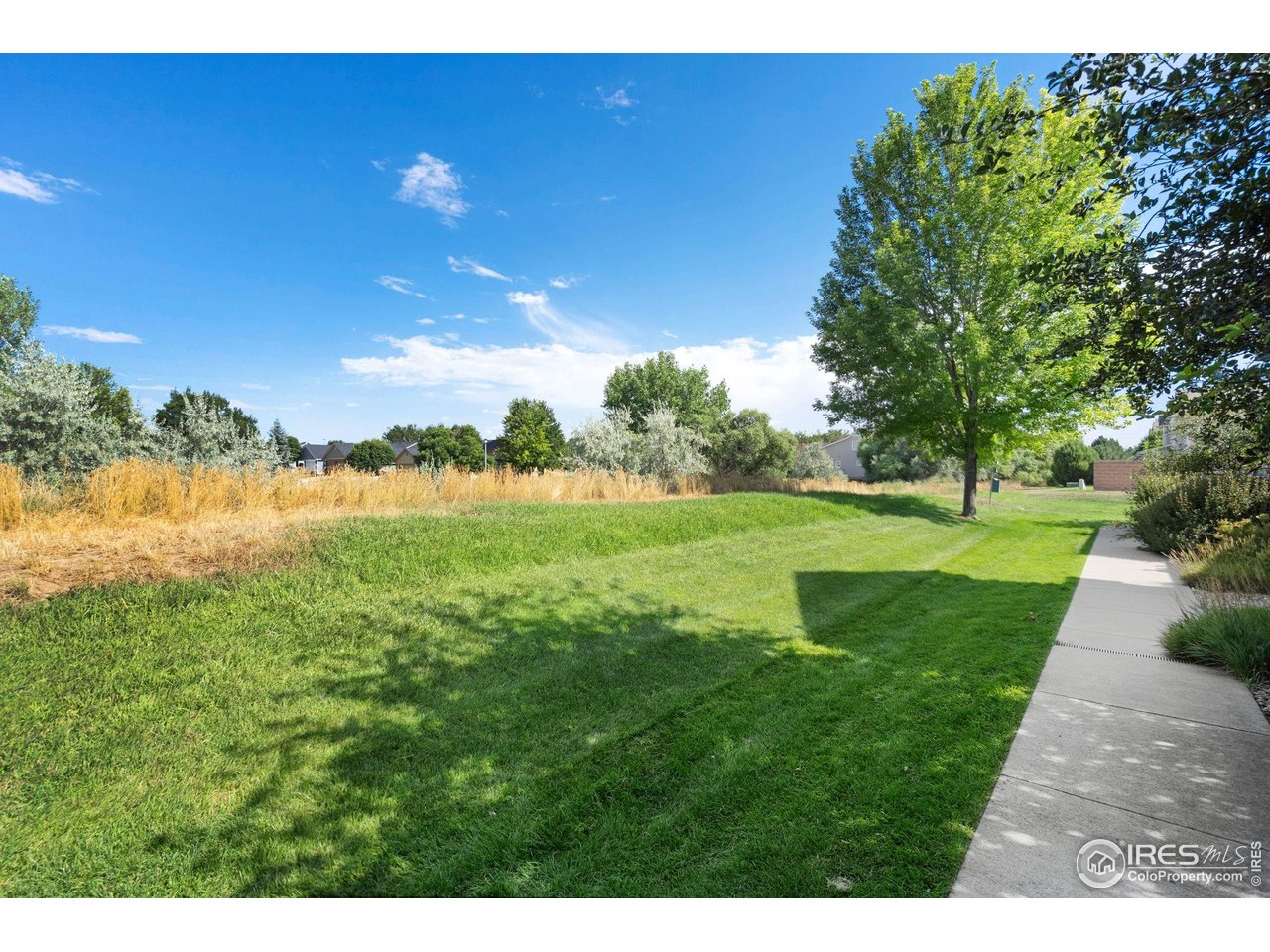 1900 68th Avenue, Unit 4 Greeley, CO 80634 - Photo 40 of 40 a view of a golf course with a lake