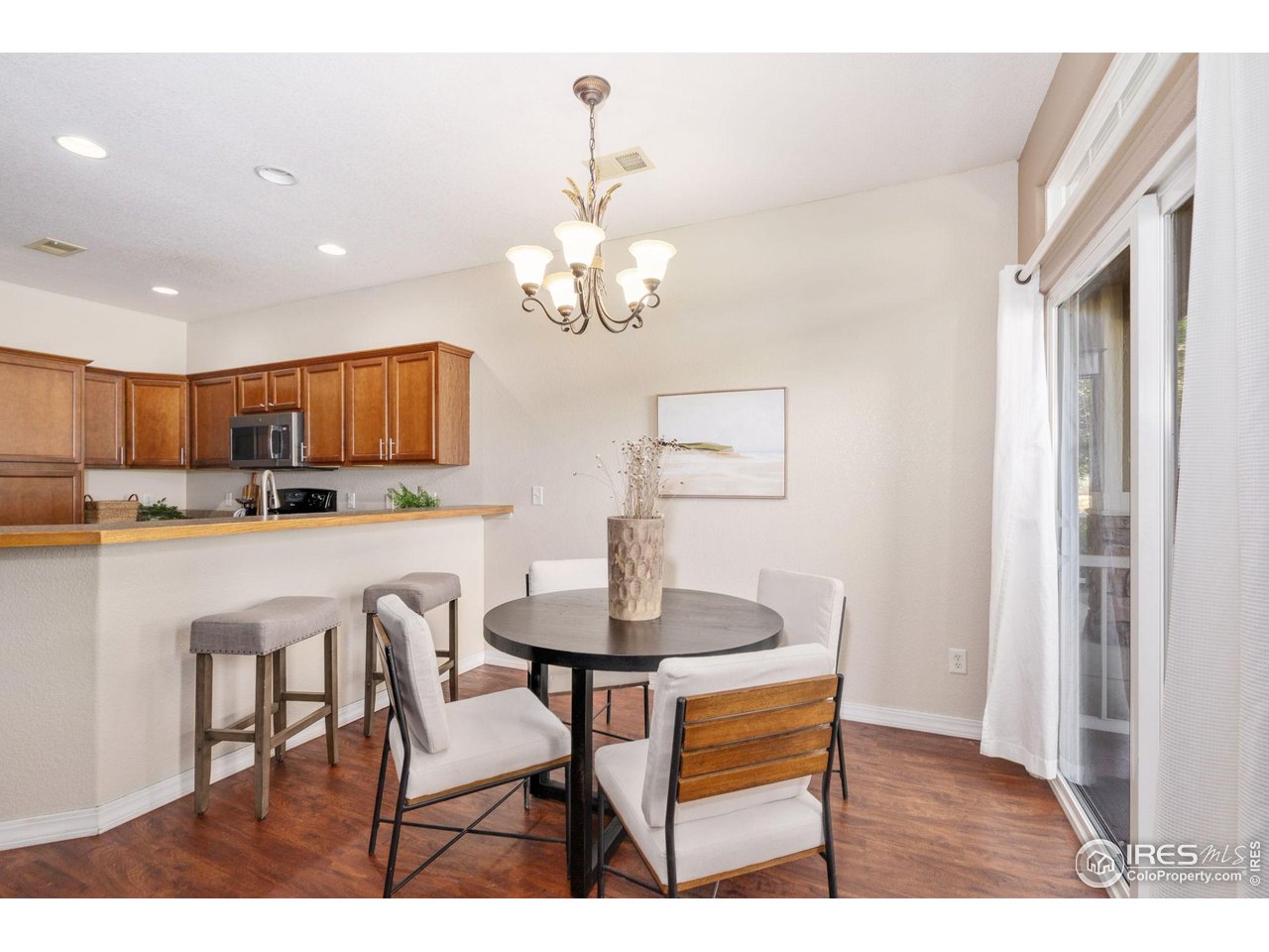 1900 68th Avenue, Unit 4 Greeley, CO 80634 - Photo 10 of 40 a dining room with kitchen island stainless steel appliances kitchen island a table and chairs