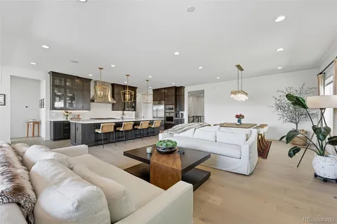 a living room with furniture a view of kitchen and living room