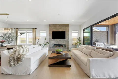 a living room with furniture large window and a flat screen tv