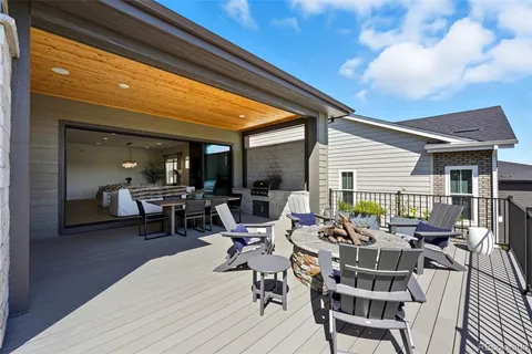 a view of a patio with table and chairs and wooden floor