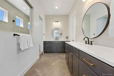 a bathroom with a double vanity sink and a mirror