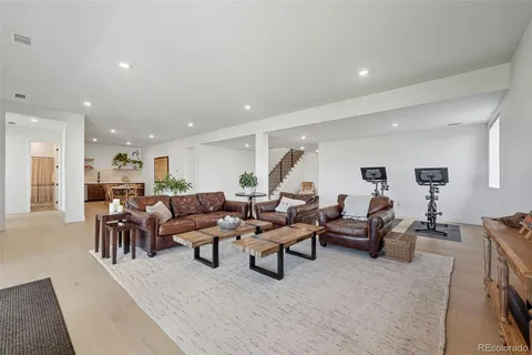 a living room with lots of furniture and a large mirror