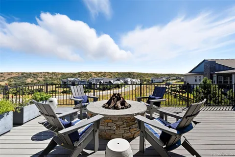 a view of a roof deck with furniture