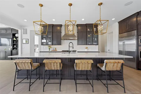 a view of kitchen island with furniture and refrigerator