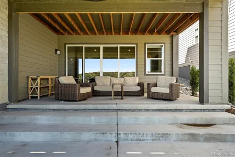 a building outdoor space with patio furniture and potted plants