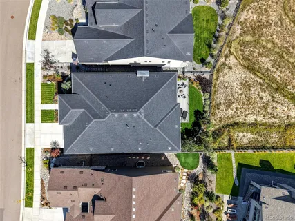 an aerial view of a house with yard