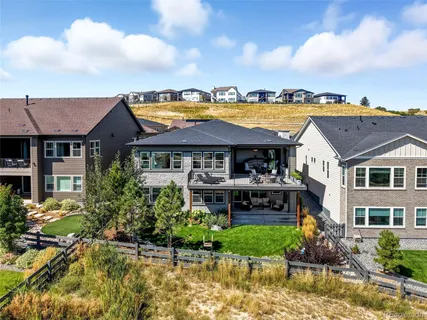 a front view of a house with a garden and swimming pool