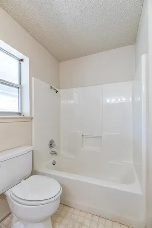 a bathroom with a bathtub and a toilet