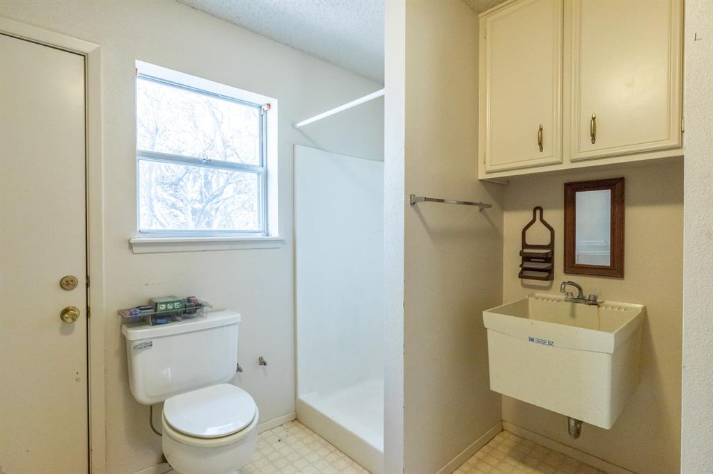 749 Cedar Street Buffalo Gap, TX 79508 - Photo 20 of 30 a bathroom with a toilet a sink and mirror