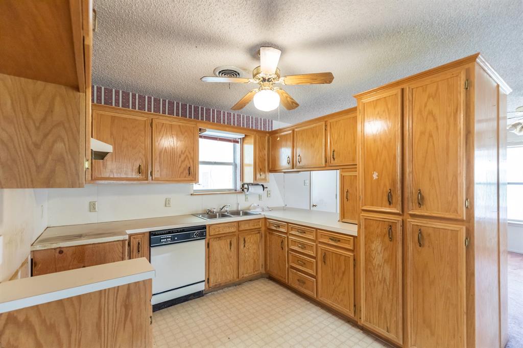 749 Cedar Street Buffalo Gap, TX 79508 - Photo 8 of 30 a kitchen with a sink cabinets stainless steel appliances and a window