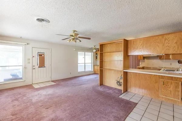 a view of a kitchen with a sink and a refrigerator
