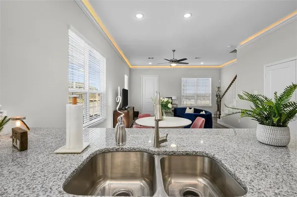 a kitchen with a sink and a granite counter tops