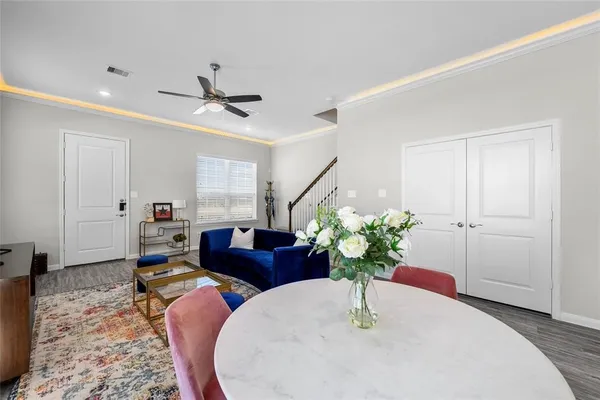 a living room with furniture flowerpot and wooden floor