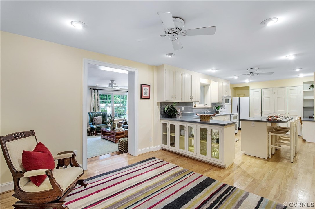233 Ross Road Henrico, VA 23229 - Photo 11 of 48 a kitchen with stainless steel appliances wooden floor dining table chairs cabinets and wooden floor