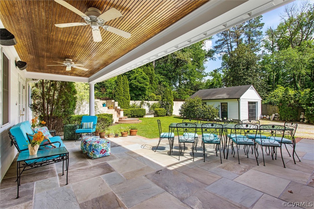 233 Ross Road Henrico, VA 23229 - Photo 15 of 48 a view of a patio with a dining table and chairs under an umbrella with a patio