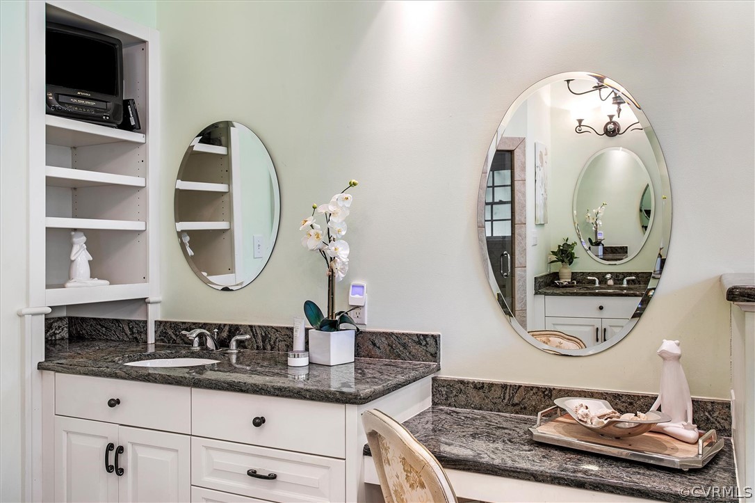 233 Ross Road Henrico, VA 23229 - Photo 22 of 48 a bathroom with a granite countertop sink mirror and vanity