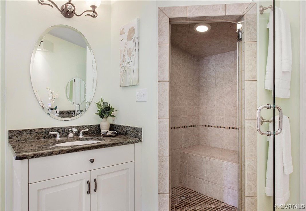 233 Ross Road Henrico, VA 23229 - Photo 23 of 48 a bathroom with a granite countertop sink a mirror and shower in a room
