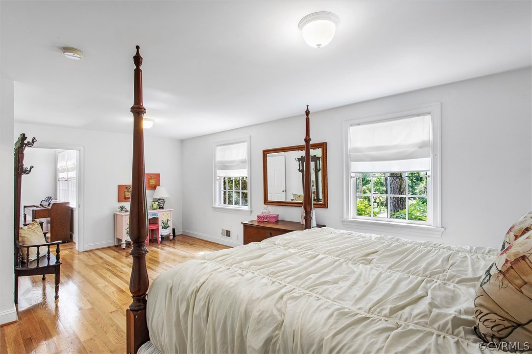 233 Ross Road Henrico, VA 23229 - Photo 28 of 48 a spacious bedroom with a large bed and a chandelier