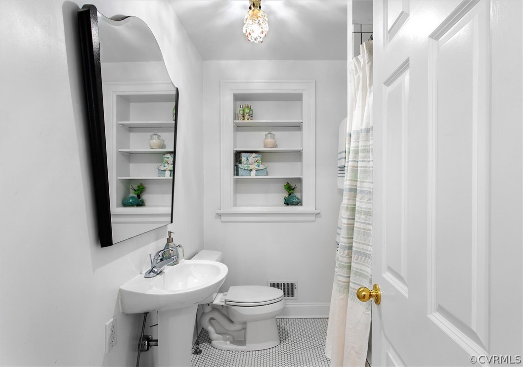233 Ross Road Henrico, VA 23229 - Photo 29 of 48 a bathroom with a sink a toilet and mirror