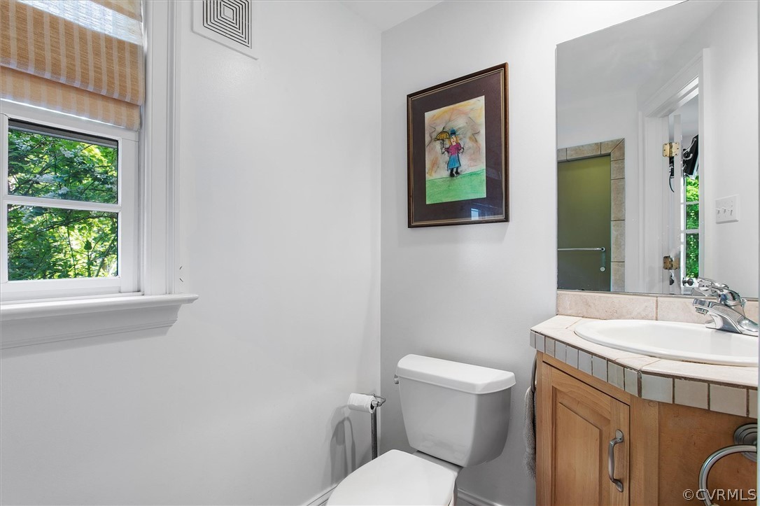 233 Ross Road Henrico, VA 23229 - Photo 31 of 48 a bathroom with a toilet a sink and a window