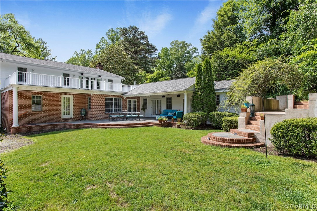 233 Ross Road Henrico, VA 23229 - Photo 41 of 48 a front view of a house with a yard table and chairs