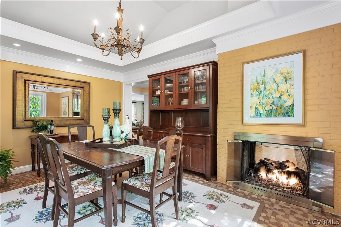 233 Ross Road Henrico, VA 23229 - Photo 8 of 48 a view of a dining room with furniture a chandelier and wooden floor