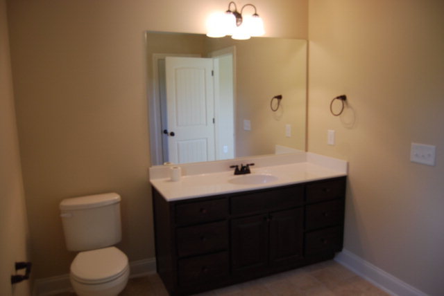 118 Laurel Ridge Forsyth, GA 31029 - Photo 16 of 21 a bathroom with a toilet a sink a mirror and vanity