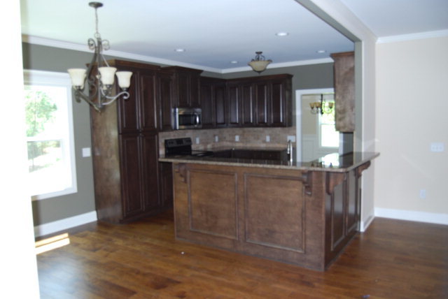 118 Laurel Ridge Forsyth, GA 31029 - Photo 7 of 21 a kitchen with kitchen island a counter top space appliances and a chandelier