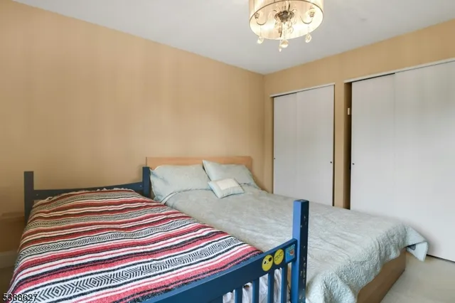 a bedroom with a bed and a chandelier