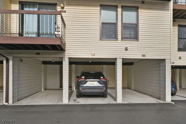 a car parked in front of a white building