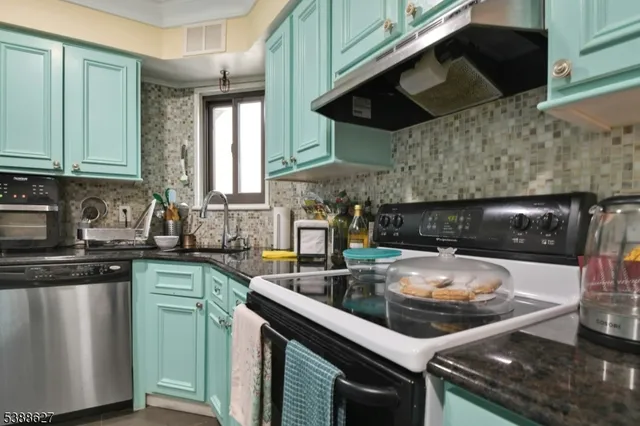 a kitchen with a sink and a stove top oven