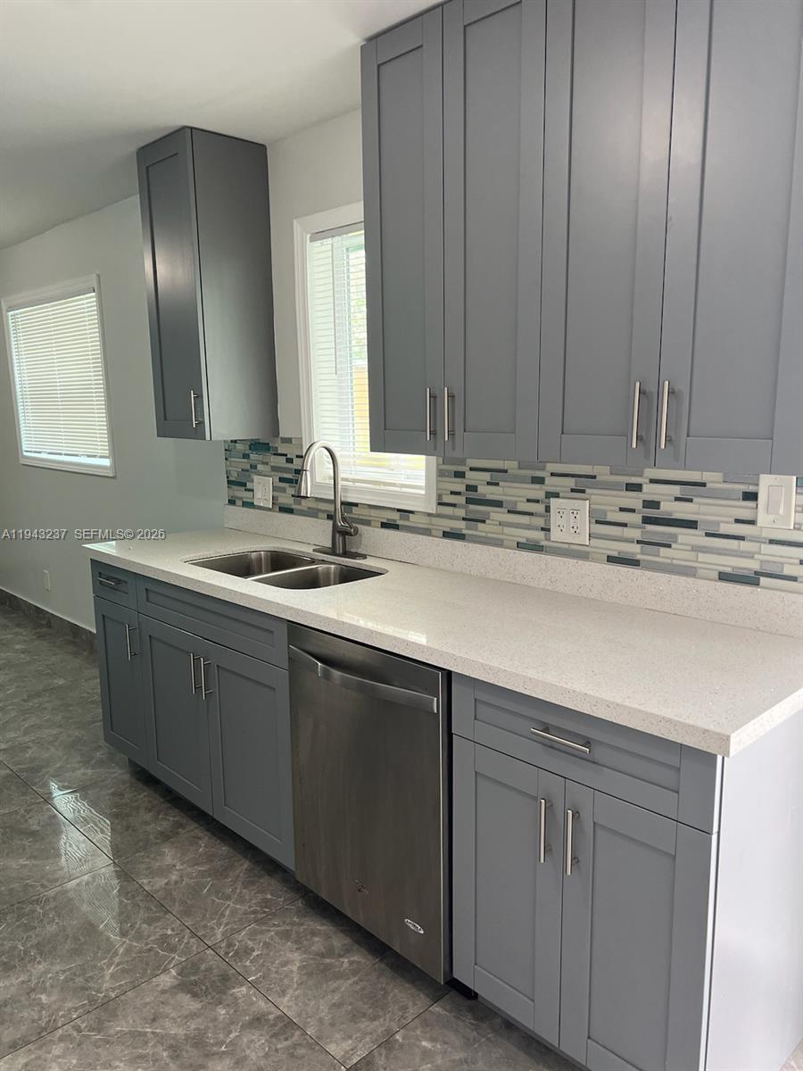 2627 Northwest 3rd Street Pompano Beach, FL 33069 - Photo 2 of 9 a bathroom with a sink and a mirror