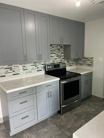 a kitchen with a stove and a sink