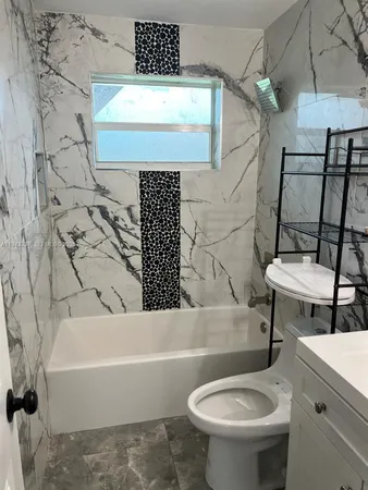 a bathroom with a sink a toilet and bathtub