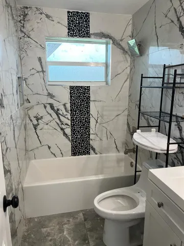 a bathroom with a sink a toilet and bathtub
