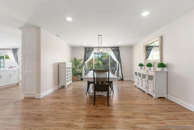 a dining room with furniture window and wooden floor