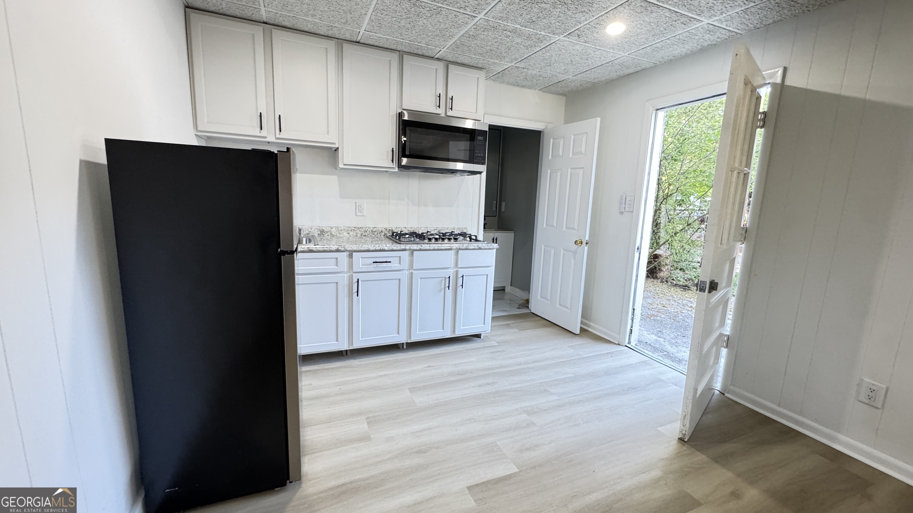 723 Sheffield Road Norcross, GA 30071 - Photo 2 of 8 a kitchen with stainless steel appliances granite countertop a refrigerator and a stove top oven
